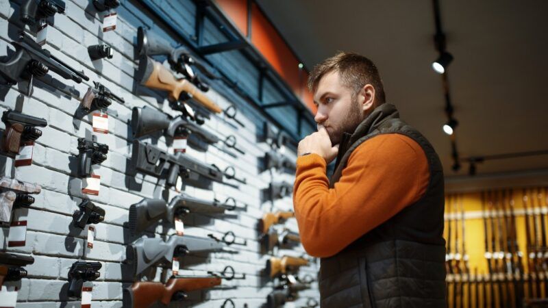 Man surveys options at gun store | Nomadsoul1 / Dreamstime.com