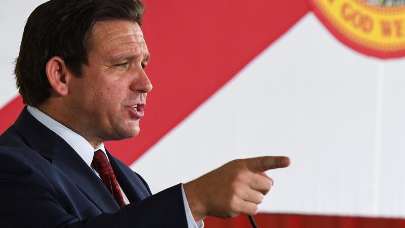 Florida Gov. Ron DeSantis points while giving a speech in front of the Florida flag | Paul Hennessy/ZUMAPRESS/Newscom