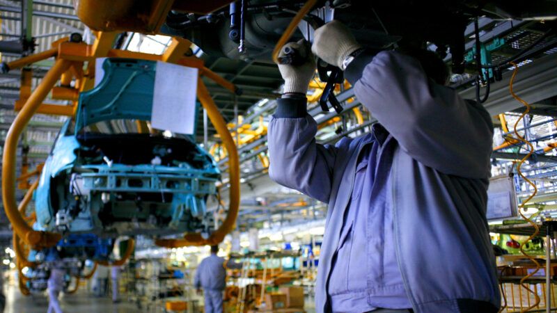 An auto worker on an assembly line. | Photo 31660527 © Tudor Vintiloiu | Dreamstime.com