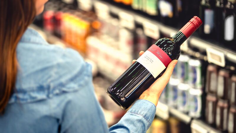 Woman examining bottle of red wide | Photo 144084107 © Tero Vesalainen | Dreamstime.com