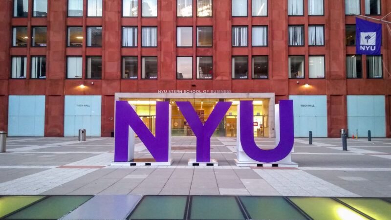 NYU logo in front of Stern Business School