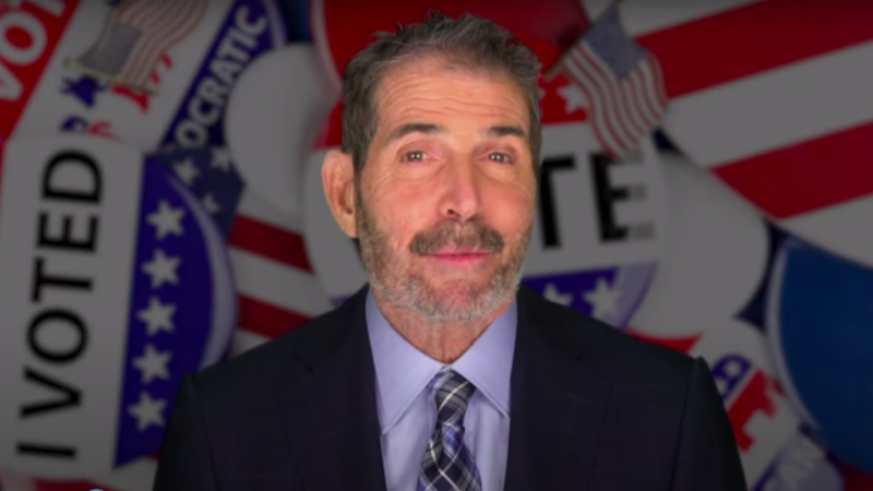 John Stossel in front of "I Voted" buttons