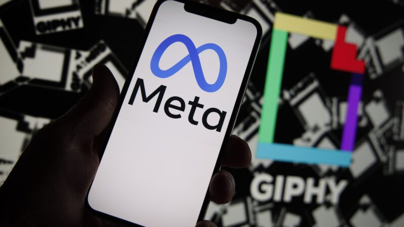Meta logo on a phone and giphy logo in the background behind