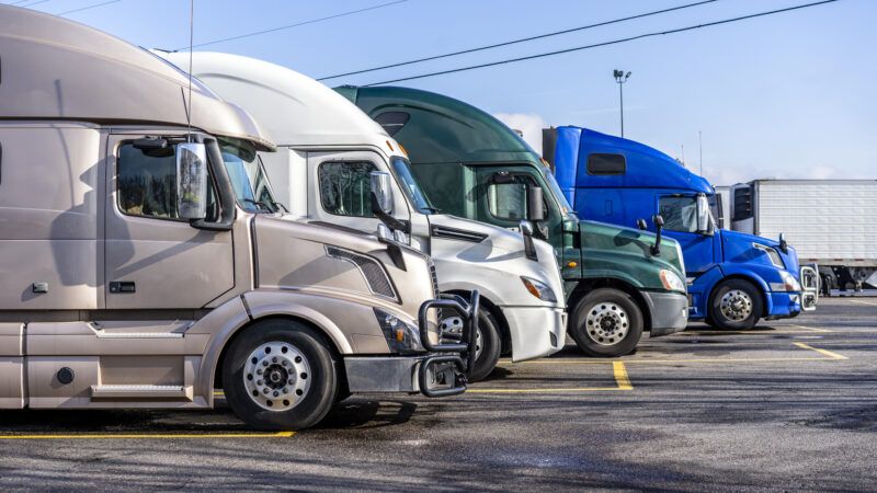 The front of trucks in line in a parking lot. | Photo 140082526 © Vitpho | Dreamstime.com