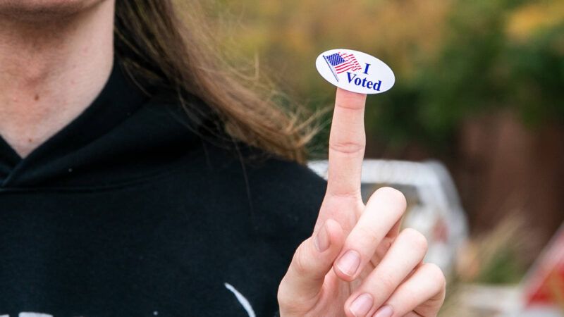 woman with "I Voted" sticker on her finger