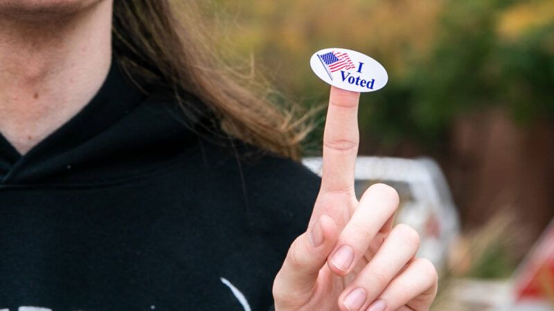 woman with "I Voted" sticker on her finger | CHINE NOUVELLE/SIPA