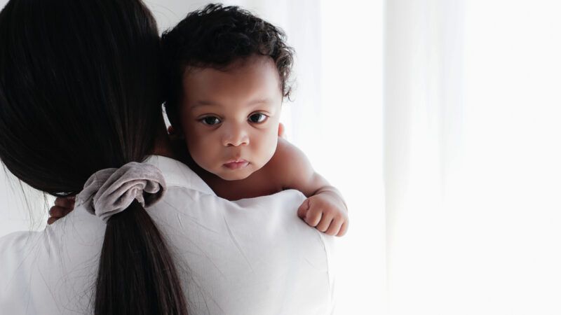 Woman holding a baby.