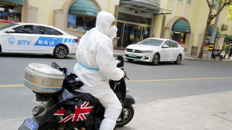 Chinese motorcyclist in COVID protection gear.