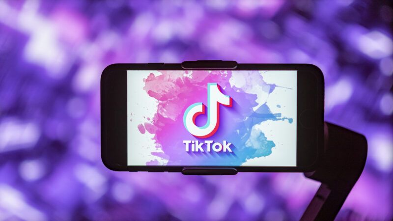 TikTok logo on phone screen against purple background | Idrees Abbas/ZUMAPRESS/Newscom