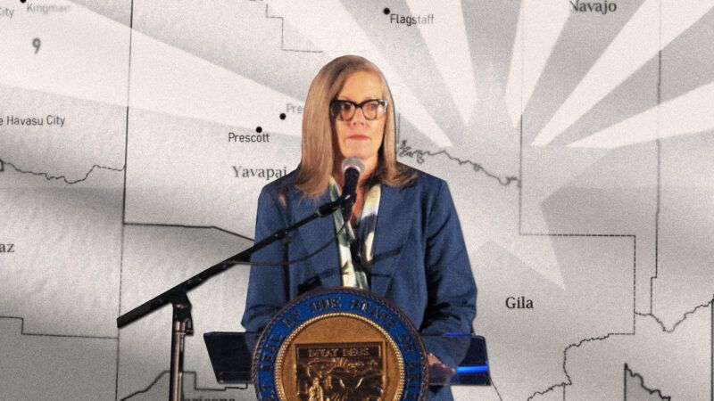 Katie Hobbs giving a speech. Background is a black and white map of the Southwesten United States.