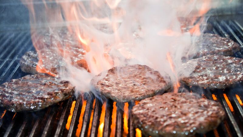 Juicy hamburgers on a flame grill