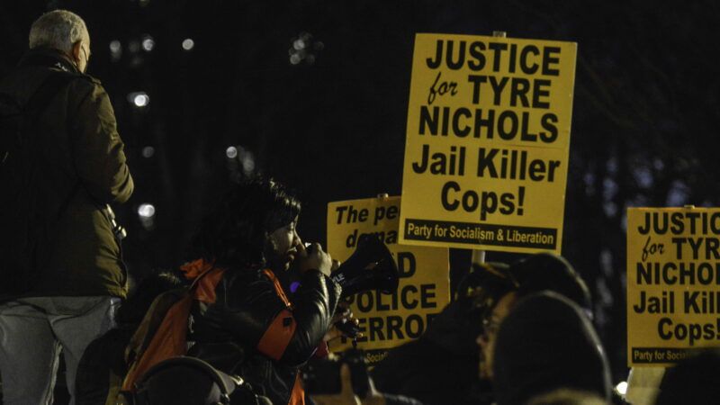 protesters holding yellow signs that say "Justice for Tyre Nichols, jail killer cops" | Deccio Serrano/Zuma Press/Newscom