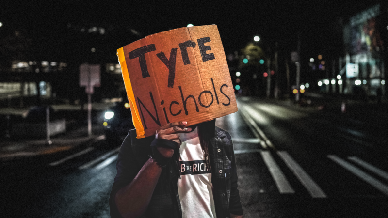 A person holds a Tyre Nichols sign at a protest against police brutality | Chin Hei Leung/ZUMAPRESS/Newscom