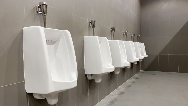 A row of urinals in a public men's bathroom.