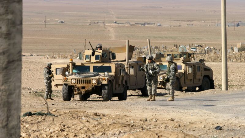 A convoy of U.S. soldiers with Humvees parked on a road in Kurdistan, Iraq.