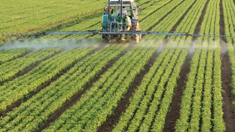 Tractor irrigates a field. | Agriculture © Ilfede | Dreamstime.com