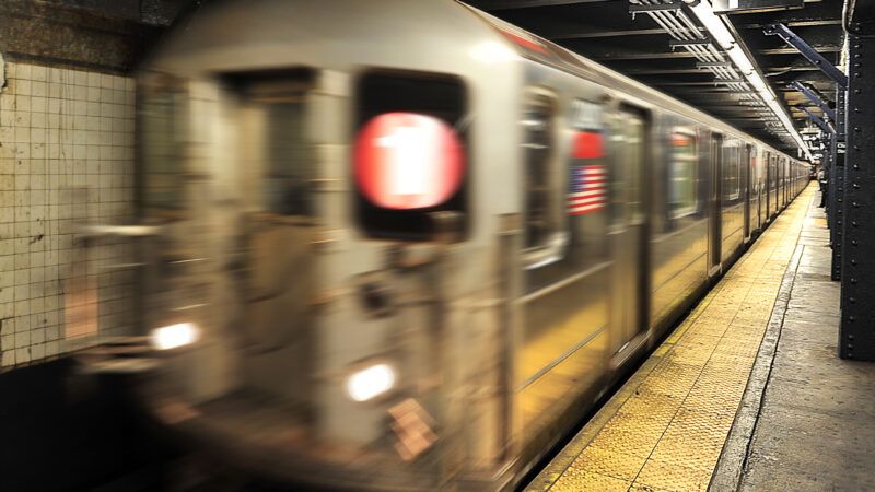 A subway train car leaving the station in New York