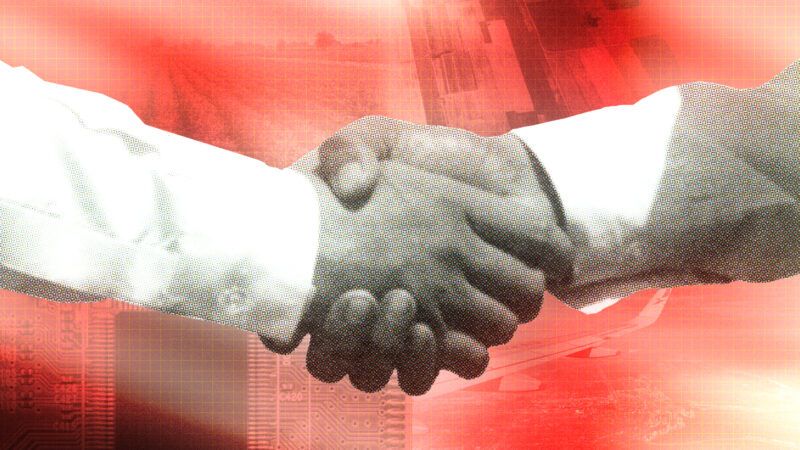 Two men are seen shaking hands in front of a backdrop showing several industries that benefit from subsidies and political favors