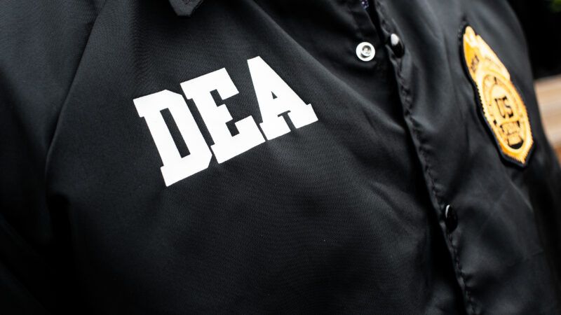 close up of chest of DEA agent with DEA logo and badge