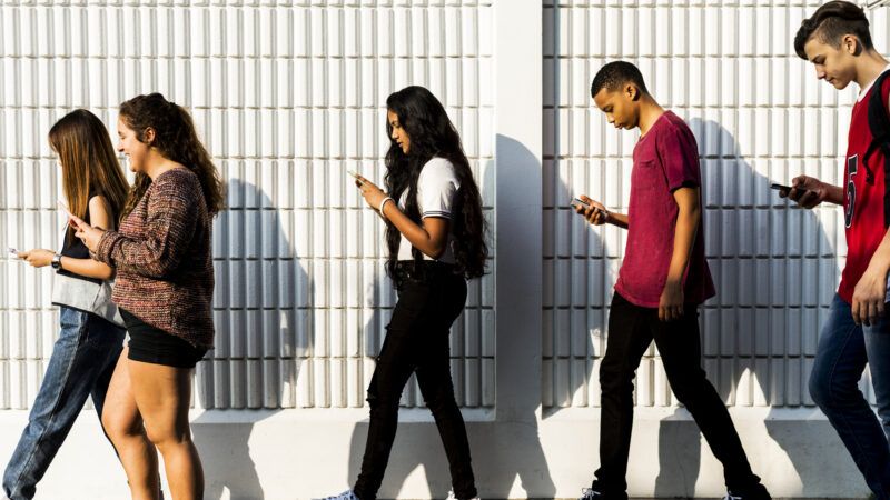 Teenagers looking at their phones