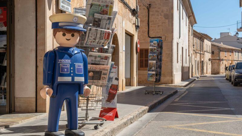 A statue of a Playmobil police figure on a Spanish street.