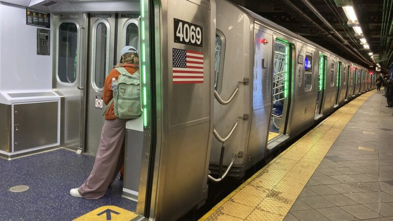 subway cars with open doors at a platform
