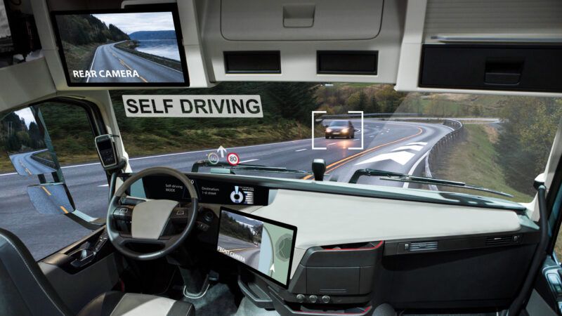 behind the wheel of a driverless truck on the road