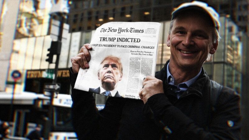 Man holds newspaper in front of Trump Tower