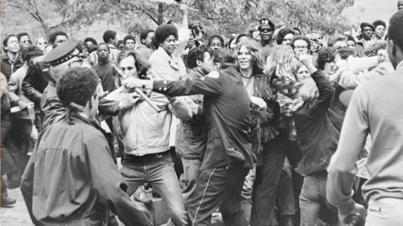 topicshistory | Photo: Demonstrators attack Chicago Police Captain Paul McLaughlin (left) and an unidentified sergeant during a clash outside the Federal Building, where eight people were on trial for conspiring to promote riots during the 1968 Democratic National Convention; Bettmann/Getty