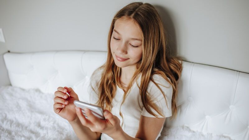 girl looking at something on her cell phone