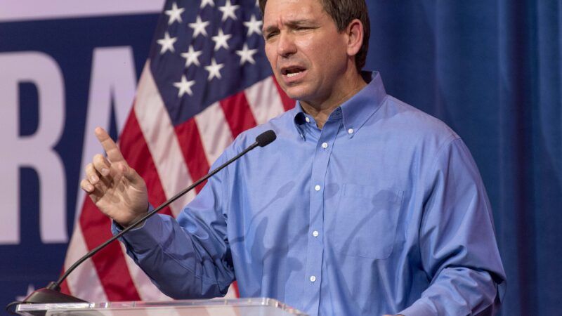 Ron DeSantis speaks behind a podium