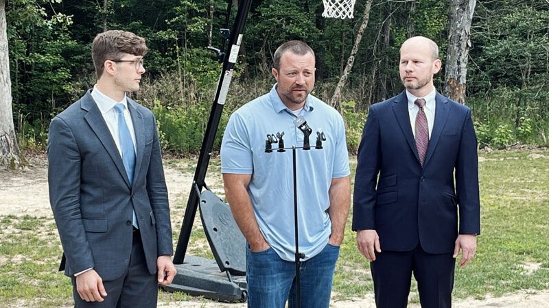 Josh Highlander holds a press conference on his property, flanked by I.J. attorneys Joshua Windham and Joe Gay. | Joe Lancaster