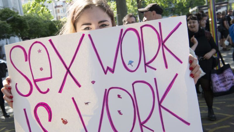 "Sex Work is Work" sign being held by a protester in Berlin