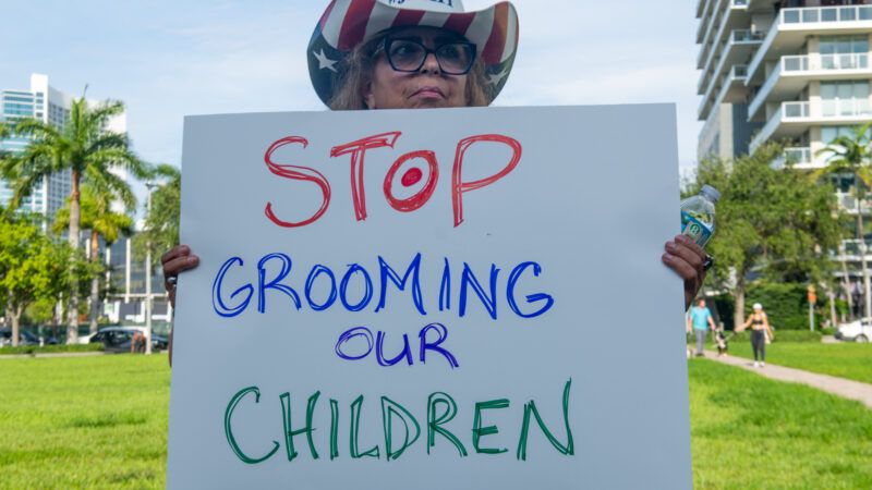 woman holds sign outside target in protest