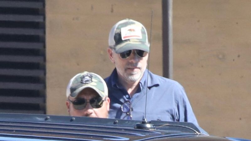 Hunter Biden walks to a car while wearing a baseball cap | Mega/Newscom/APCAN/Newscom