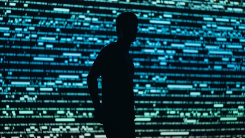 Silhouette of man against blurry digital lines backdrop | Photo by <a href="https://unsplash.com/@chrisyangchrisfilm?utm_source=unsplash&utm_medium=referral&utm_content=creditCopyText">Chris Yang</a> on <a href="https://unsplash.com/photos/1tnS_BVy9Jk?utm_source=unsplash&utm_medium=referral&utm_content=creditCopyText">Unsplash</a>   