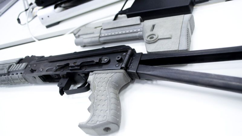Parts of a 3D-printed semi-automatic rifle against a white background. | 3d Printed Gun © Mari1408 | Dreamstime.com