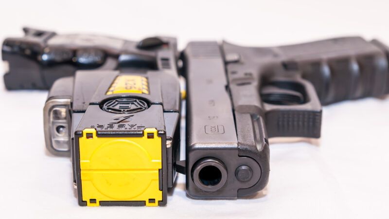 A Taser and a Glock 9mm placed side-by-side. | Bill H | Dreamstime.com