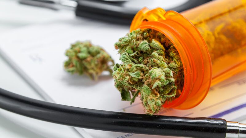 Close-up of marijuana in a prescription pill bottle, a stethoscope, and a prescription pad. | Tyler Oneill | Dreamstime.com