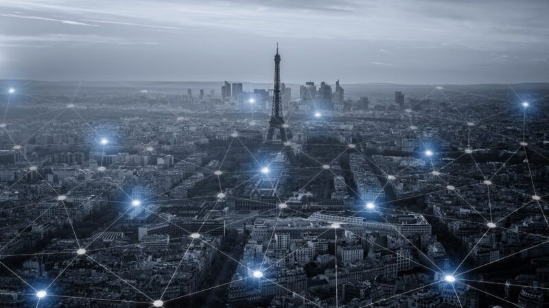 Eiffel Tower amid a cityscape with a network grid overlay | Prasit Rodphan | Dreamstime.com