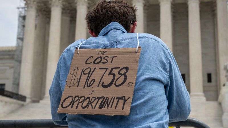 Student loan protester wears cardboard sign in front of the Supreme Court | Alejandro Alvarez/Sipa USA/Newscom