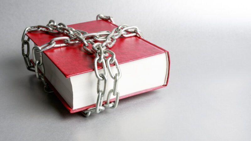 A thick red hardcover book is chained shut. | Andrey Metelev | Dreamstime.com