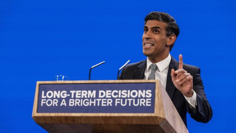 British Prime Minister Rishi Sunak speaking in front of a blue background, behind a podium that reads "LONG-TERM DECISIONS FOR A BRIGHTER FUTURE" | News Licensing / MEGA / Newscom/NEWSUK/Newscom