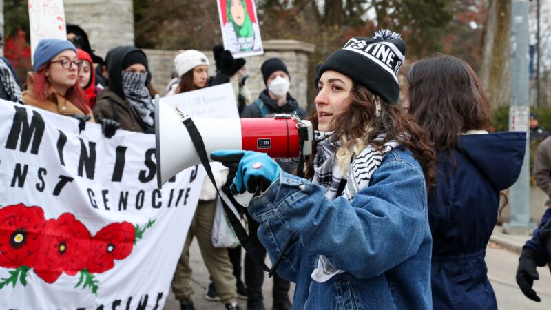 A young woman with a bullhorn leads a crowd in a pro-Palestine protest at Pennsylvania State Universtiy. | Paul Weaver/ZUMAPRESS/Newscom