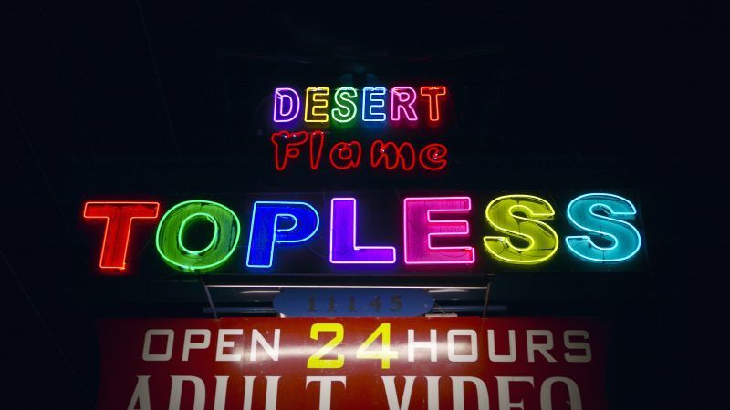 Neon signs reading TOPLESS, advertising a topless bar. | Joe Sohm | Dreamstime.com
