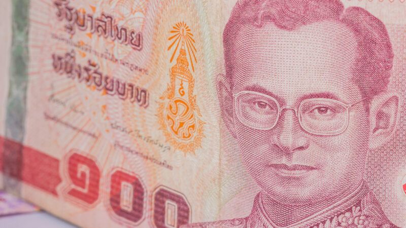 Close-up of the baht, Thailand's currency, with a picture of the country's king. | Sirayot Bunhlong | Dreamstime.com