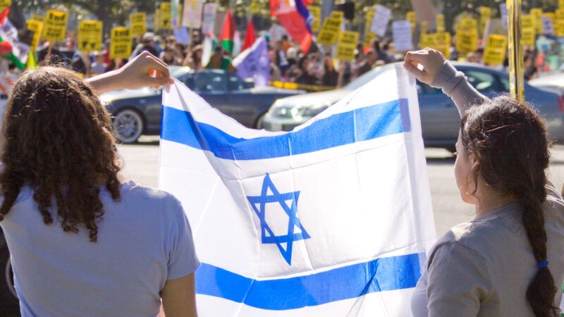 Two protesters hold an Israeli flag. | Salvador Ceja | Dreamstime.com