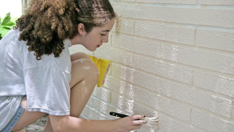Teenager painting a brick wall. | Photo 1051904 © Brian T. Young | Dreamstime.com