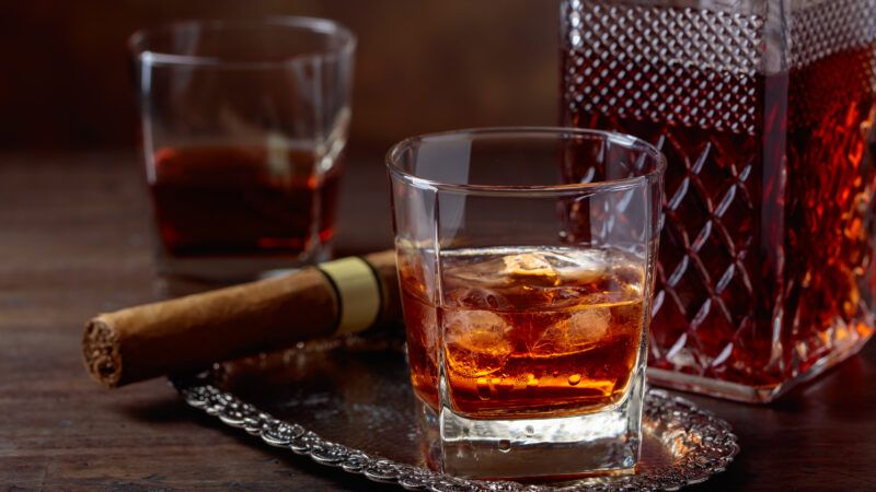 Whiskey on the rocks, a decanter, and a cigar | Igorr | Dreamstime.com
