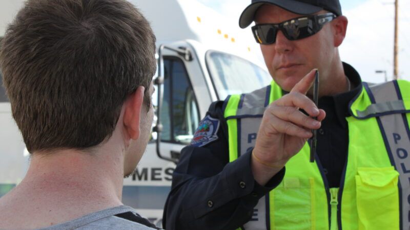A police officer administers a roadside impairment test on a motorist. | Rebekah Zemansky | Dreamstime.com
